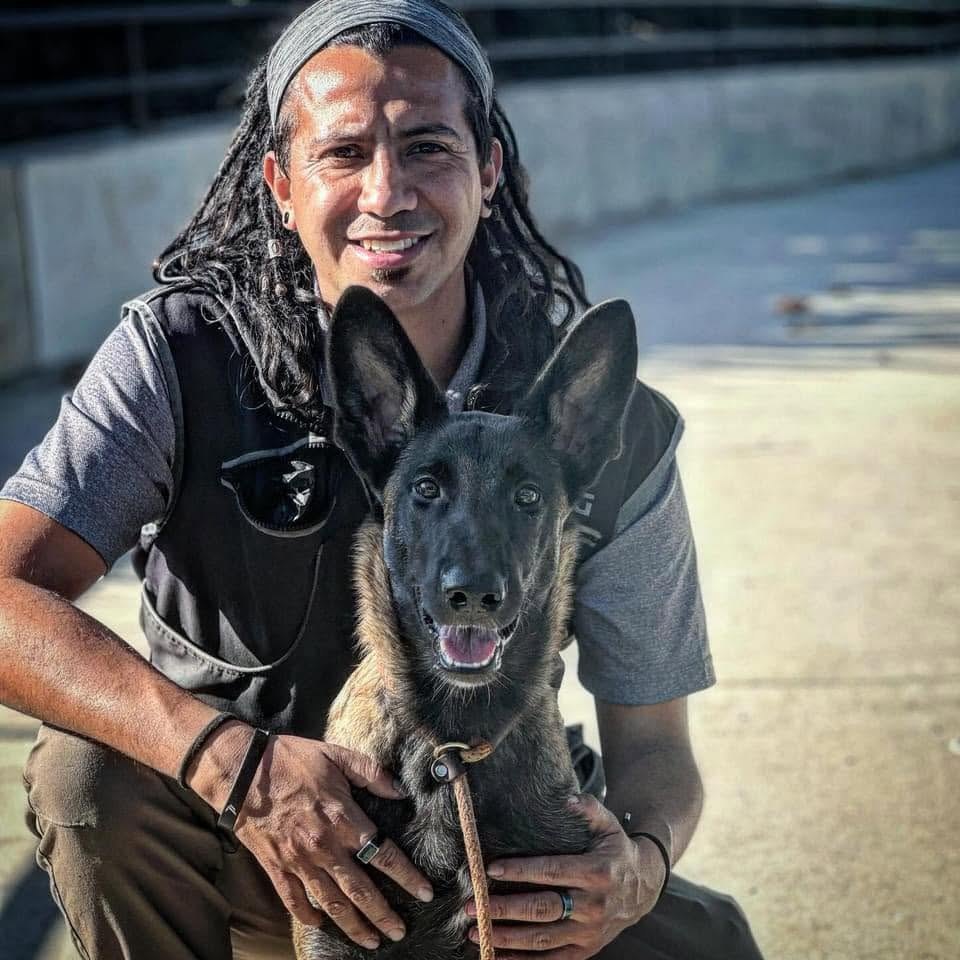 Bryan Rojas, trainer at Agoge K9, with a Malinois puppy